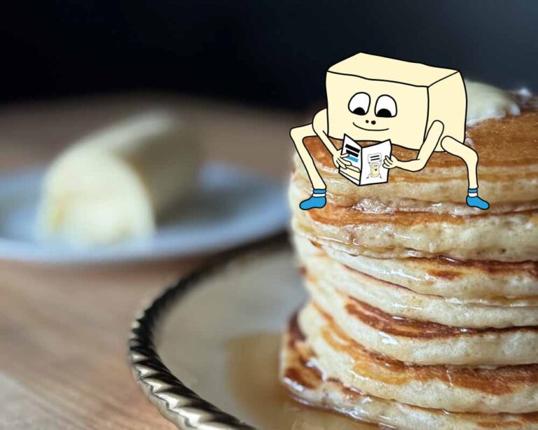 Drawing of a stick of butter reading zine sitting on a real photo of pancakes with a thing of butter in the background